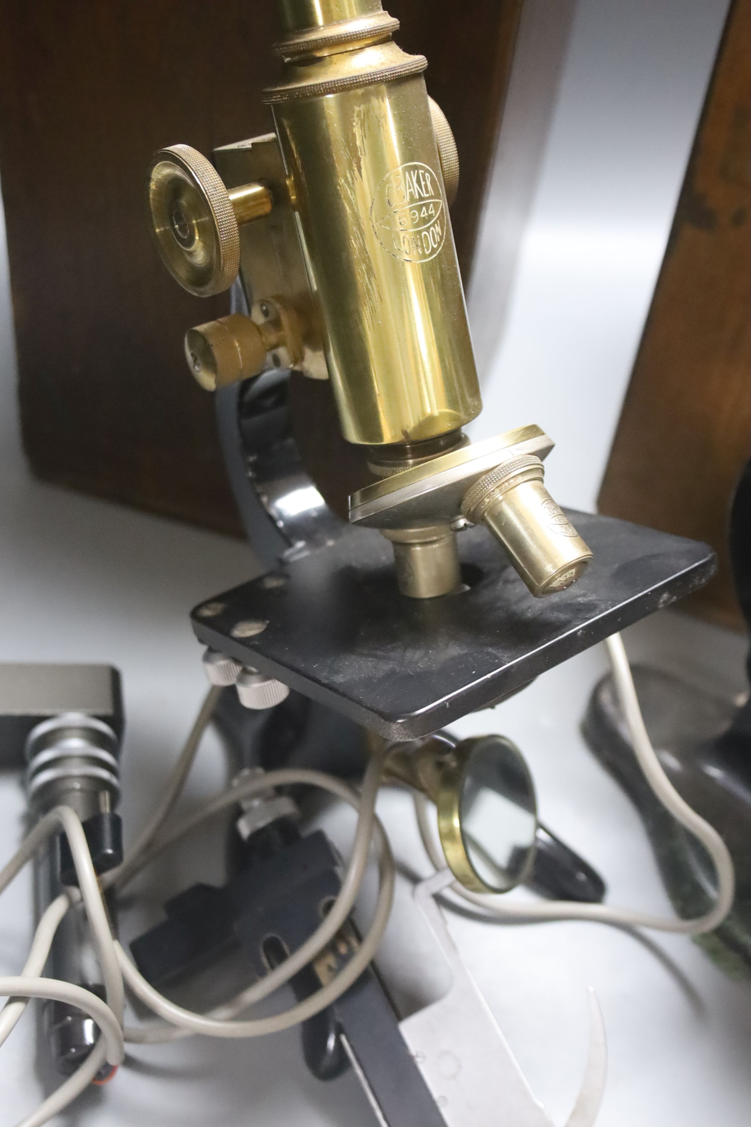 Two mahogany cased microscopes by C. Baker, London, with lenses